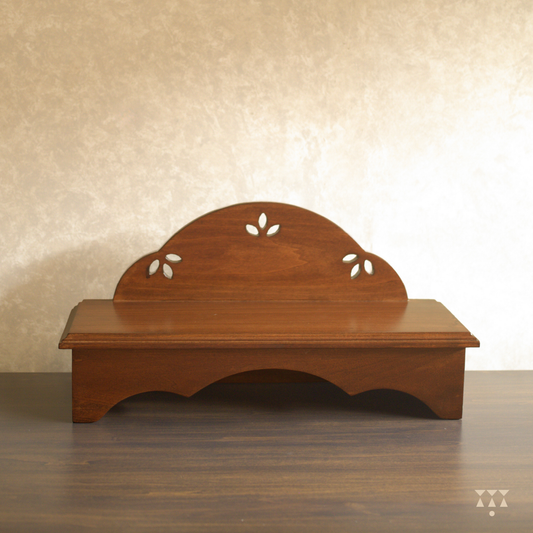 Wooden pooja platform placed on a table.