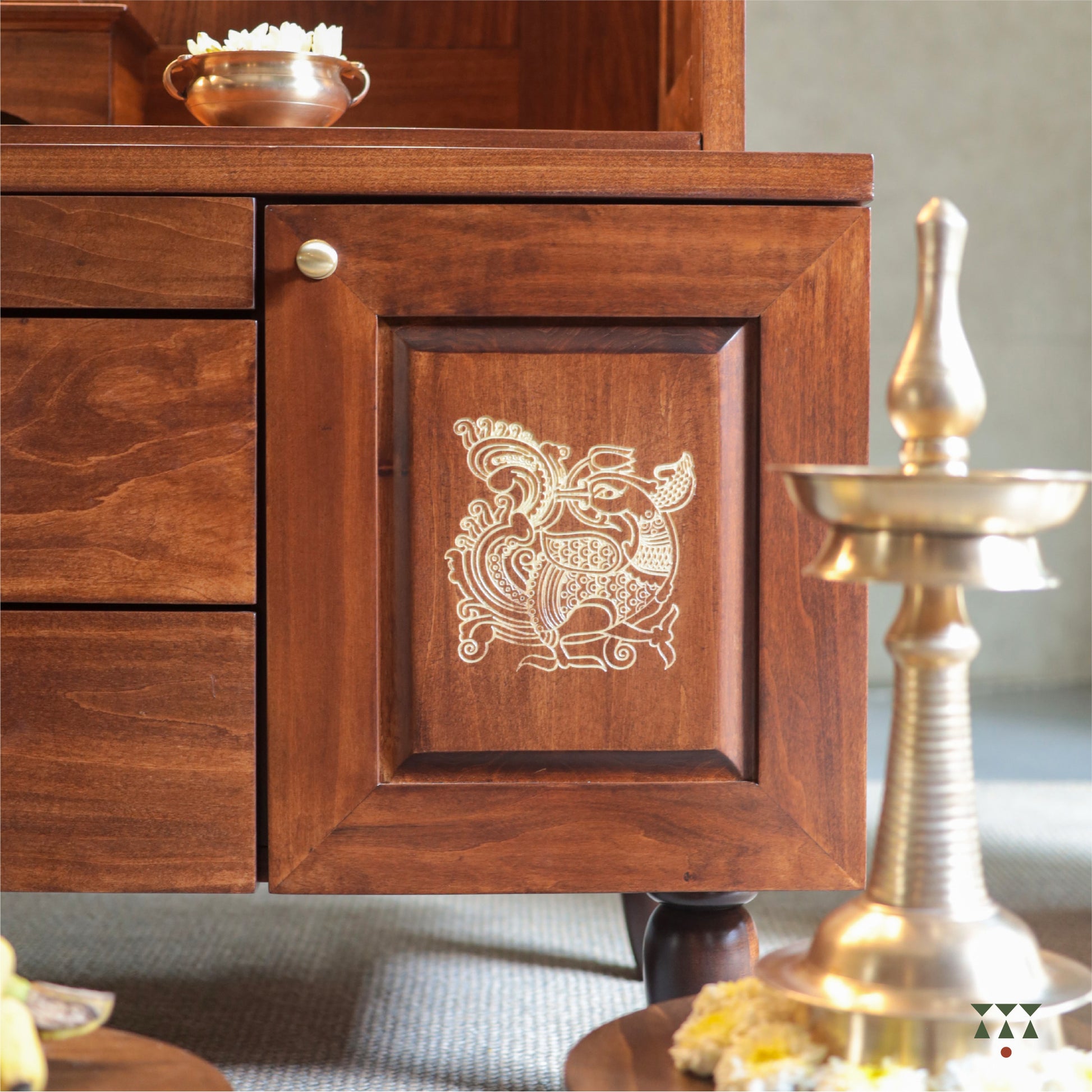 Wooden pooja mandir with intricate carvings and gold accents, featuring an annapakshi motif