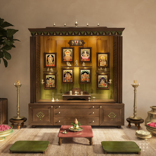 Wooden pooja altar with decorative elements, tanjore deity frames and brass accessories in a room setting.