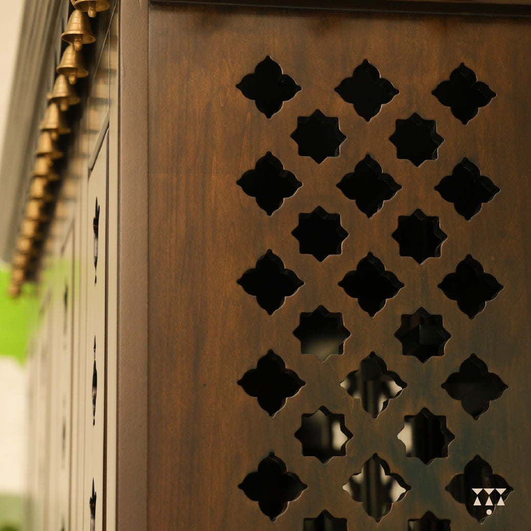 Close up side view of Vikat temple showing decorative wooden panel with geometric cut-out patterns