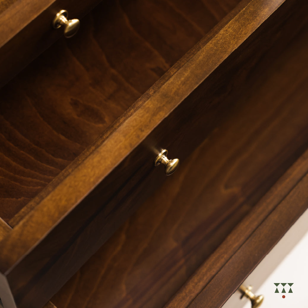 Close-up & top view of Vikat temple's wooden drawer and storage cabinet with brass handles in an open position